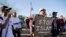 FILE - Demonstrators shout during a "Freedom of Speech Rally Round II" outside the Islamic Community Center in Phoenix, Arizona, May 29, 2015.