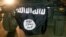 FILE - The flag of the Islamic State is displayed during celebrations in Mosul, Iraq.