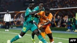 Senegal's midfielder Krepin Diatta fights for the ball with Ivory Coast's forward Max-Alain Gradel during the 2023 Africa Cup of Nations round of 16 match, at the Stade Charles Konan Bann, Jan. 29, 2024.