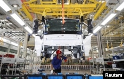 An employee works on a new energy vehicle production line at a BYD factory in Huaian, Jiangsu province, China, Aug. 26, 2024. (China Daily via Reuters)