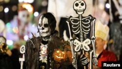 People in costume participate in the 45th Annual Village Halloween Parade in Manhattan, New York, U.S.