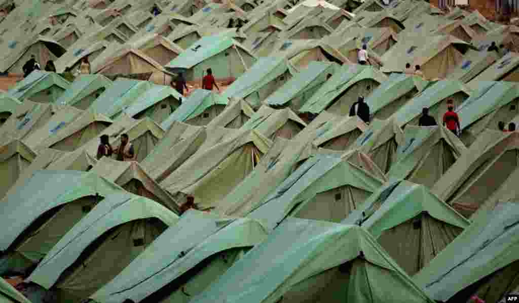 March 16: Men who fled the unrest in the Libya stay in a refugee camp at the Tunisia-Libyan border. (AP/Emilio Morenatti)