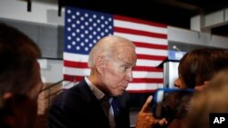 Former Vice President and Democratic presidential candidate Joe Biden greets audience members during a rally in Cedar Rapids, Iowa, April 30, 2019.