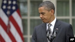 President Barack Obama turns to head back to the Oval Office after delivering a statement on the monthly jobs report in the Rose Garden of the White House in Washington, July 8, 2011