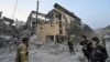 Rescuers stand at a site of a Russian missile strike in Kryvyi Rih, Ukraine, on Aug. 27, 2024.