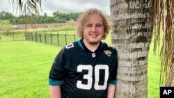 FILE - In this April 18, 2021, photo provided by Jennifer Sampson, her son Zach Sampson, 16, poses in his Florida yard. Sampson was hospitalized twice during the pandemic after feeling suicidal. 