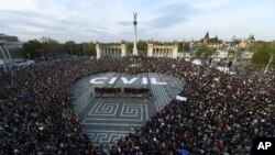 FILE - People gather to protest against then-planned NGO and Central European University laws, in Heroes Square in Budapest, Hungary, April 12, 2017. The European Union has launched legal action against Hungary because of new rules seen discriminating against civic groups that receive funds from abroad.