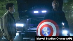 This image released by Disney shows Danny Ramirez, left, and Anthony Mackie in a scene from Marvel Studios' "Captain America: Brave New World." 