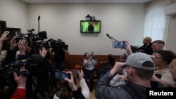 Russian opposition leader Alexey Navalny is seen on a screen via video link from a penal colony in the Vladimir Region during a hearing at the Basmanny district court in Moscow, Russia April 26, 2023.