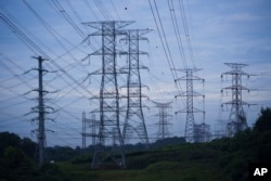 FILE - Power lines are seen near a power plant near Dengkil on the outskirt of Kuala Lumpur, Malaysia, on Sept. 11, 2023. (AP Photo/Vincent Thian)