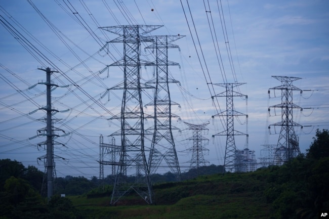 FILE - Power lines are seen near a power plant near Dengkil outside of Kuala Lumpur, Malaysia, on Sept. 11, 2023. (AP Photo/Vincent Thian)