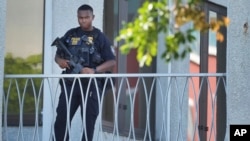 An officer patrols outside the courthouse where Ryan Wesley Routh, suspected in an apparent assassination attempt of former President Donald Trump, will attend a hearing, in West Palm Beach, Florida, Sept. 23, 2024. Routh's son has been arrested on child sexual abuse charges.