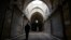 A Syrian man walks through Aleppo's centuries-old market. which still hasn't come back to life more than a year after government forces retook rebel-held neighborhoods around the Old City, Jan. 21, 2018. 