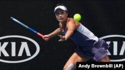 FILE - China's Peng Shuai makes a forehand return to Japan's Nao Hibino during their first round singles match at the Australian Open tennis championship in Melbourne, Australia, Tuesday, Jan. 21, 2020.