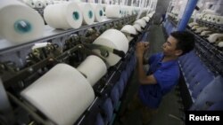 FILE - A man works at a yarn weaving plant in Ha Nam province, outside Hanoi, Vietnam, Oct. 7, 2015. Obama's three-day visit to Vietnam, starting Monday, is expected to be a watershed in the growing economic and strategic relationship between the two coun