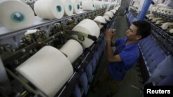 A man works at a yarn weaving plant in Ha Nam province, outside Hanoi, Vietnam, Oct. 7, 2015. 