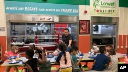 FILE - Students finish their lunch break at Lowell Elementary School in Albuquerque, New Mexico, Aug. 22, 2023.