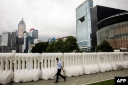 A man walks past extra barricades that have been erected near the Legislative Council in Hong Kong on May 26, 2020.