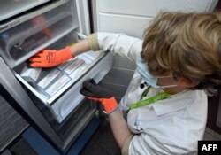 FILE - Vaccines are stored in a freezer following the delivery of the first part of the Moderna vaccine to be administered against the novel coronavirus, Covid-19, are emptied at the ZNA Middelheim hospital in Antwerp, Belgium, January 15, 2021.