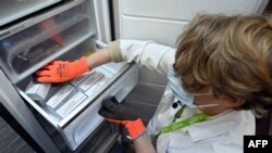 Vaccines are stored in a freezer following the delivery of the first part of the Moderna vaccine to be administered against the novel coronavirus, Covid-19, are emptied at the ZNA Middelheim hospital in Antwerp on January 15, 2021. (Photo by ERIC…
