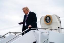 FILE - President Donald Trump arrives at Morristown Municipal Airport to attend a fundraiser at Trump National Golf Club in Bedminster, Oct. 1, 2020, in Morristown, N.J.