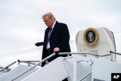 FILE - President Donald Trump arrives at Morristown Municipal Airport to attend a fundraiser at Trump National Golf Club in Bedminster, Oct. 1, 2020, in Morristown, N.J.
