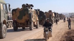 In this frame grab from video taken Feb. 2, 2020, a large Turkish military convoy is seen at the northern town of Sarmada in Idlib province, Syria.