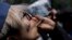 FILE - A young man smokes marijuana to celebrate the International Day for Cannabis in Mexico City, April 20, 2018. 