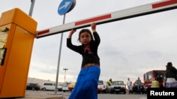 A member of Romania's ethnic Roma minority arrives at Bucharest airport, Aug. 9, 2012. 