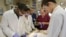 A group of students work on a dead body in the anatomy lab at the medical school at Indiana University Northwest.