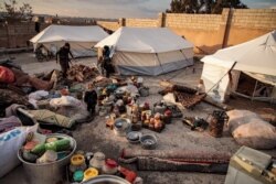 Supplies are scattered outside tents of displaced Syrians, who fled from government forces' advance on Maaret al-Numan in the south of Idlib province, at a camp for the displaced near the town of Dana near the border with Turkey, Dec. 27, 2019.