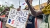 TOPSHOT - Protesters hold an anti-France placard during a demonstration on independence day in Niamey on August 3, 2023.