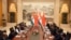 In this photo released by the Indian Ministry of External Affairs, Indian Prime Minister Narendra Modi, center left, and Chinese President Xi Jinping, center right, sit with delegation members for a meeting in Wuhan, China, April 27, 2018. 