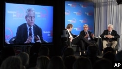 Former Washington Post reporter Bob Woodward, is seen on the monitor as moderator Charlie Rose, left, Woodward and Bernstein speak during an event to commemorate the 40th anniversary of Watergate, June 11, 2012.