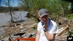 Dan Dionne looks over his former deck outside his home in Edenville, Mich., May 20, 2020.