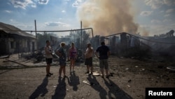 Local residents stand near destroyed houses after a Russian strike on a neighborhood in Pokrovsk, Ukraine, on Aug. 3, 2024.