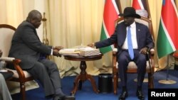 FILE - South Sudan's President Salva Kiir sits with ex-vice president and former rebel leader Riek Machar before their meeting in Juba, South Sudan, Sept. 11, 2019.