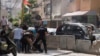 Supporters of a Shiite group allied with Hezbollah help an injured comrade during armed clashes that erupted during a protest in the southern Beirut suburb of Dahiyeh, Lebanon, Oct. 14, 2021.