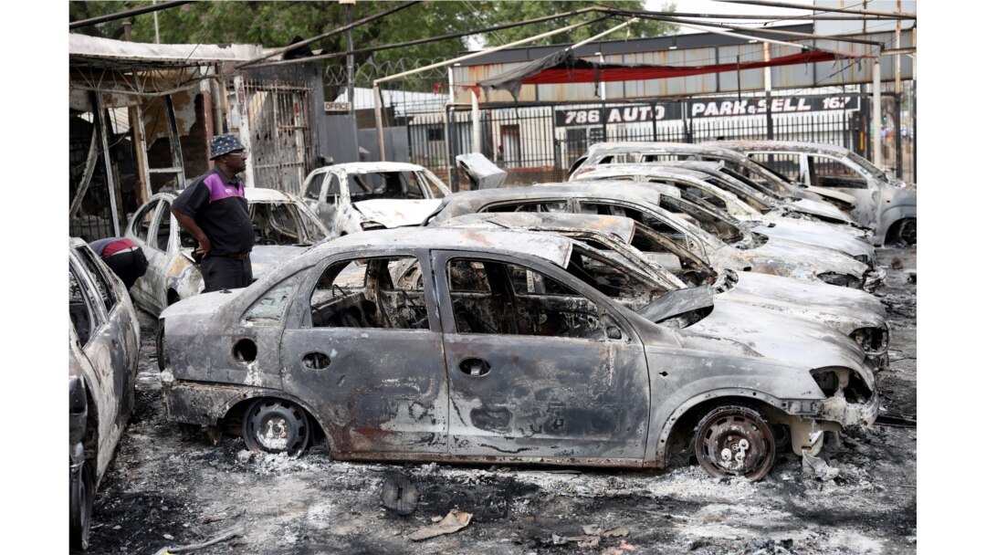 A man looks at cars that were burned during the latest spate of xenophobic attacks, at a car dealership in Johannesburg, South Africa, Sept. 5, 2019.