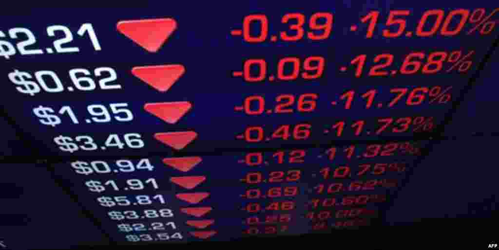 Display boards at the Australian Stock Exchange flicker with news of a falling market in Sydney, Friday, Aug. 5, 2011. The Australian benchmark S&P/ASX-200 index plunged 168.6 points, or 3.94 percent, at 4,107.9 shortly after opening. (AP Photo/Rick Rycro