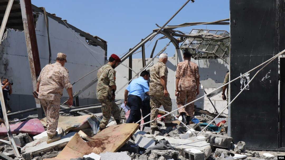 Libyan officials investigate the bombing of a detention center holding civilian migrants that killed dozens of people and injured more than 130, pictured on July 3, 2019. (H. Murdock)