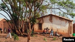 FILE - Children sit on a tree branch in Lilongwe, Malawi, Oct. 4, 2018. The country's government has announced it is taking steps to better protect children from being forced or tricked into prostitution. Rights campaigners are not convinced.