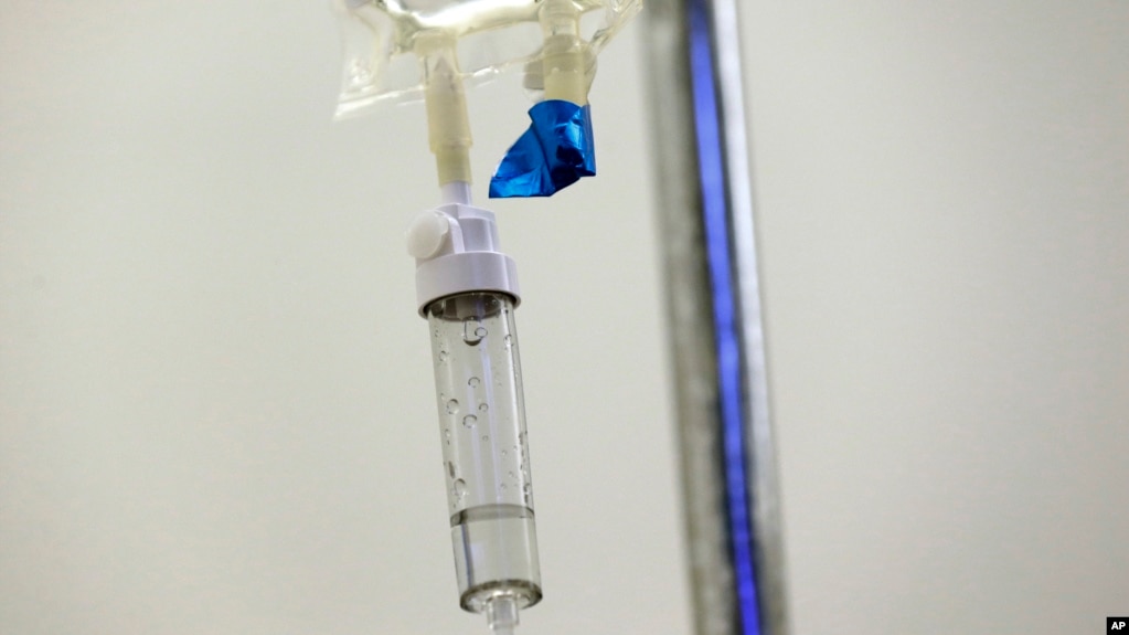 FILE - In this May 25, 2017 file photo, chemotherapy drugs are administered to a patient at a hospital in Chapel Hill, N.C. (AP Photo/Gerry Broome, File)
