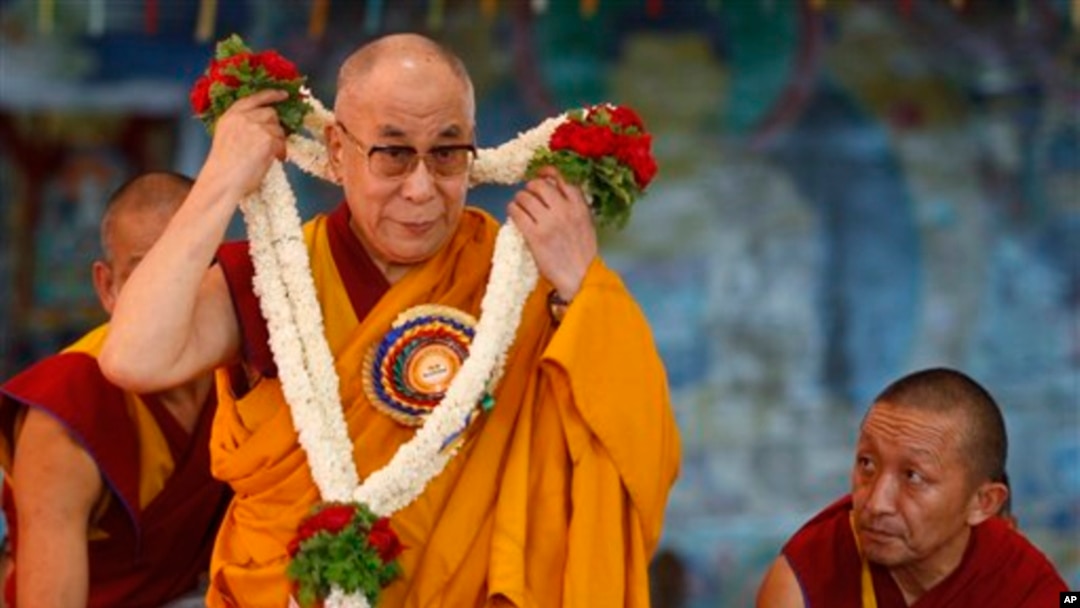 FILE - Tibetan spiritual leader the Dalai Lama takes off a garland presented to him for his 78th birthday at a Tibetan Buddhist monastery in Bylakuppe, about 220 kilometers (137 miles) southwest of Bangalore, India, July 6, 2013. 