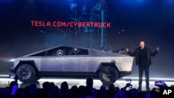 FILE - Tesla CEO Elon Musk introduces the Cybertruck in Hawthorne, Calif., Nov. 21, 2019. The unveiling of Tesla’s electric pickup truck went off script when supposedly unbreakable window glass shattered twice when hit with a large metal ball. 