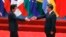 FILE - Japanese Prime Minister Shinzo Abe, left, and Chinese President Xi Jinping approach each other for a handshake before a group photo session for the G-20 Summit in Hangzhou, in eastern China's Zhejiang province, Sept. 4, 2016. The two will meet Thursday, when Abe starts a three-day visit to China.