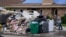A resident dumps debris while gutting his flooded home in the aftermath of Hurricane Ida in LaPlace, La., Sept. 7, 2021.