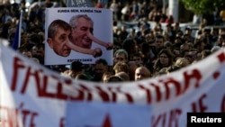 Demonstrators hold placards during a protest rally against Czech Finance Minister Andrej Babis and President Milos Zeman in Prague, Czech Republic, May 10, 2017. The placard reads: 'Tax frauds.' 