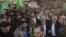 The exiled Hamas chief, Khaled Meshaal (L), and Gaza's Hamas prime minister, Ismail Haniyeh, wave as they parade through the streets following Meshaal's arrival in Gaza City, December 7, 2012.