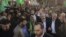 The exiled Hamas chief, Khaled Meshaal (L), and Gaza's Hamas prime minister, Ismail Haniyeh, wave as they parade through the streets following Meshaal's arrival in Gaza City December 7, 2012.